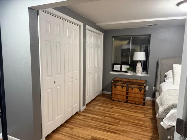 a room with wooden floor and furniture