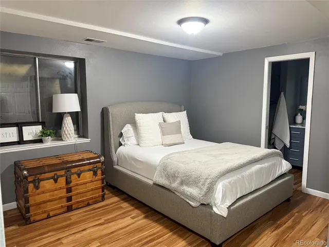 a bedroom with a bed and a night stand