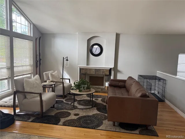 a living room with furniture and a fireplace