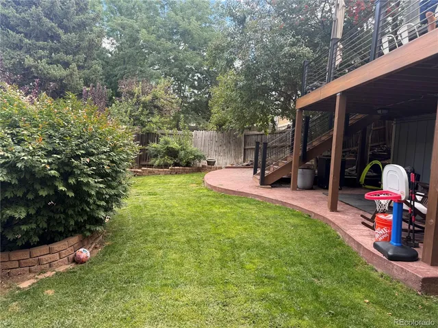 a view of a backyard with sitting area and slide
