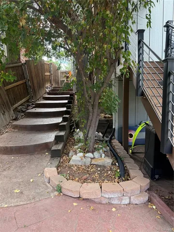 a view of backyard with a table and chairs
