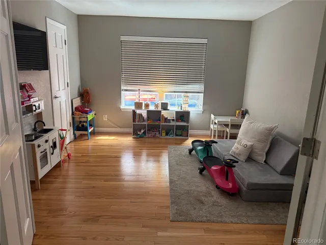 a living room with furniture window and a flat screen tv