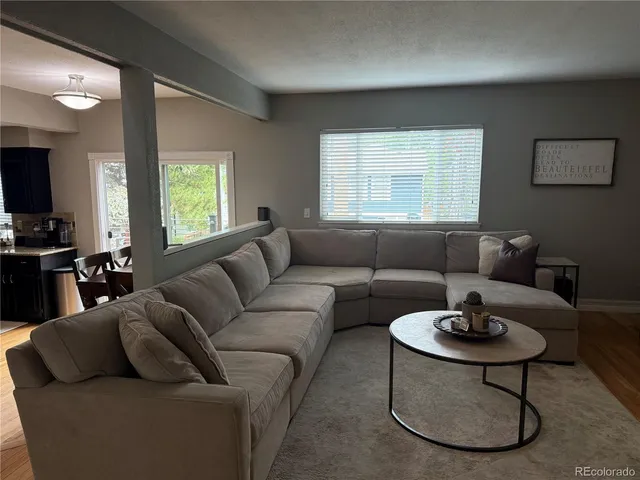 a living room with furniture a window and a dining table