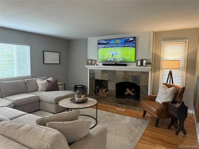 a living room with furniture a window and a fireplace