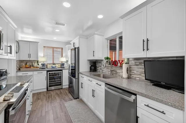 a kitchen with stainless steel appliances a stove sink microwave and cabinets