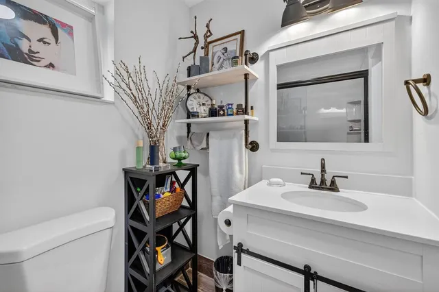 a bathroom with a sink a mirror and a toilet