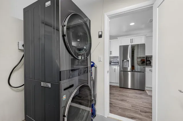 a kitchen with a refrigerator a washer and dryer