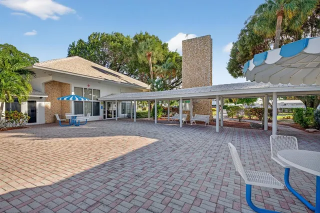 a view of a swimming pool with a yard and plants