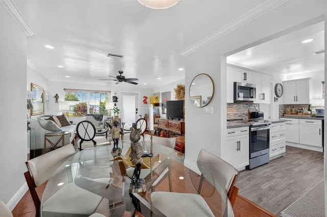 a kitchen with stainless steel appliances granite countertop a refrigerator and a sink