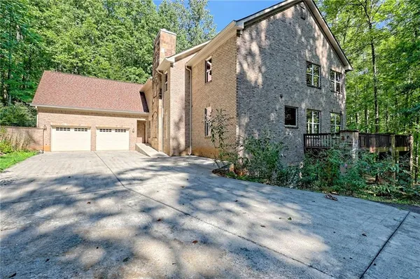 a view of a bedroom with wooden floor and a window