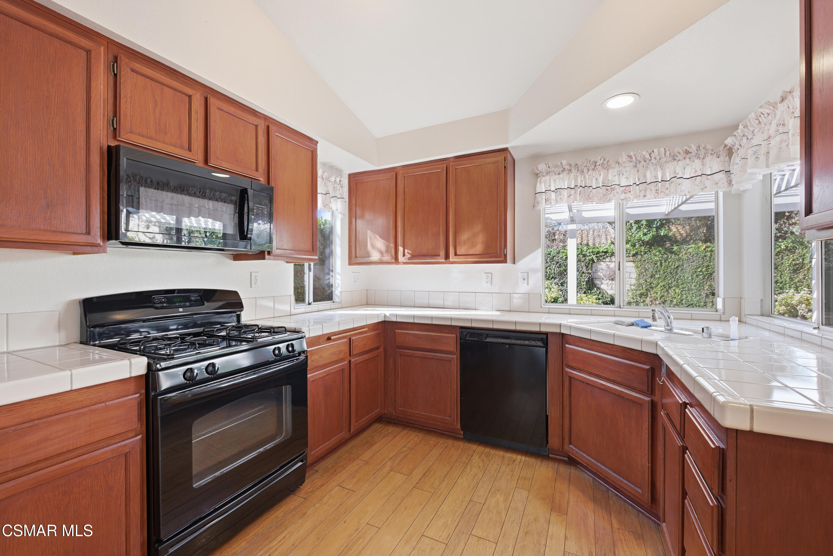 2565 Winthrop Court Simi Valley, CA 93065 - Photo 15 of 37 a kitchen with stainless steel appliances granite countertop wooden cabinets stove top oven and sink