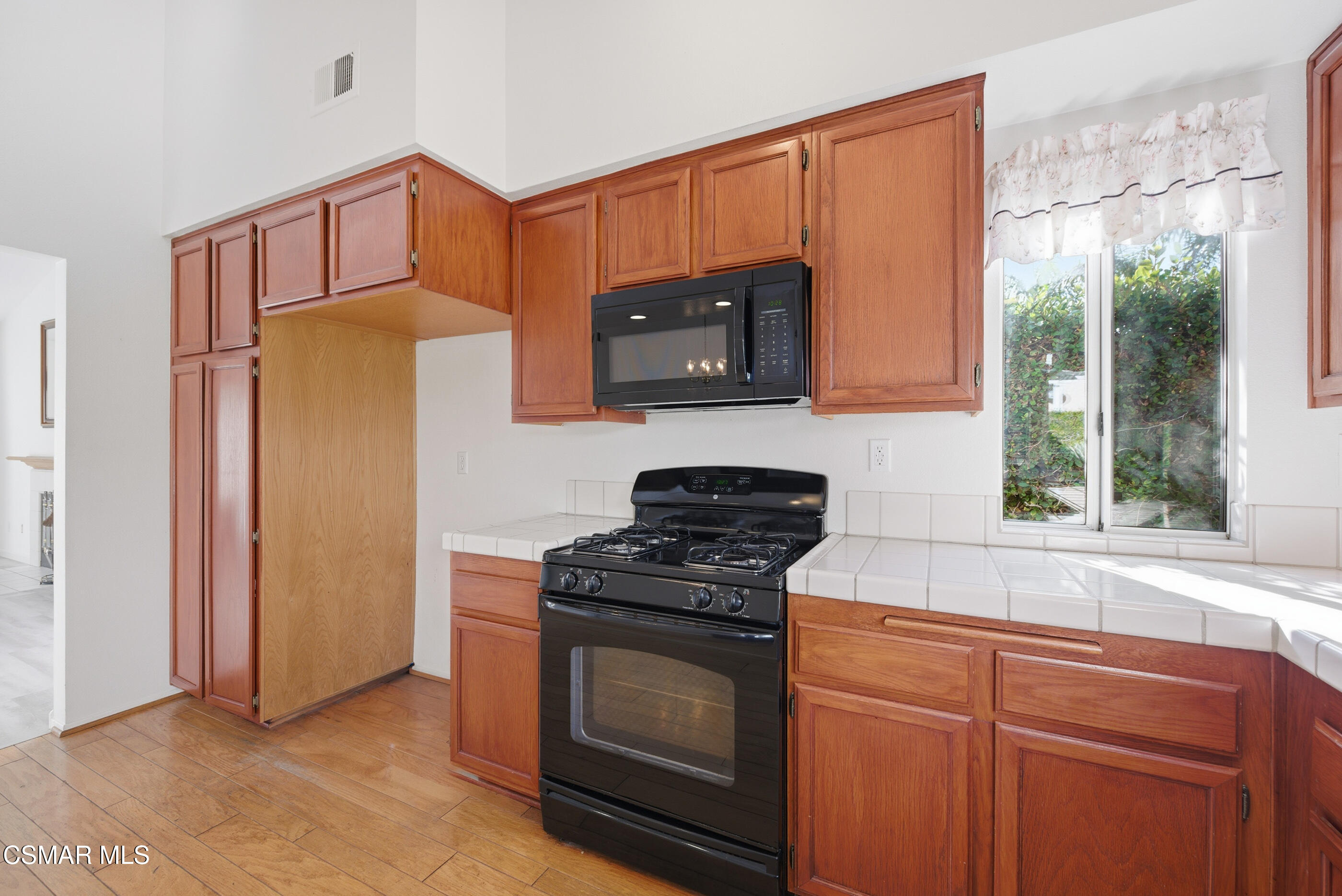 2565 Winthrop Court Simi Valley, CA 93065 - Photo 17 of 37 a kitchen with granite countertop cabinets stainless steel appliances and a window