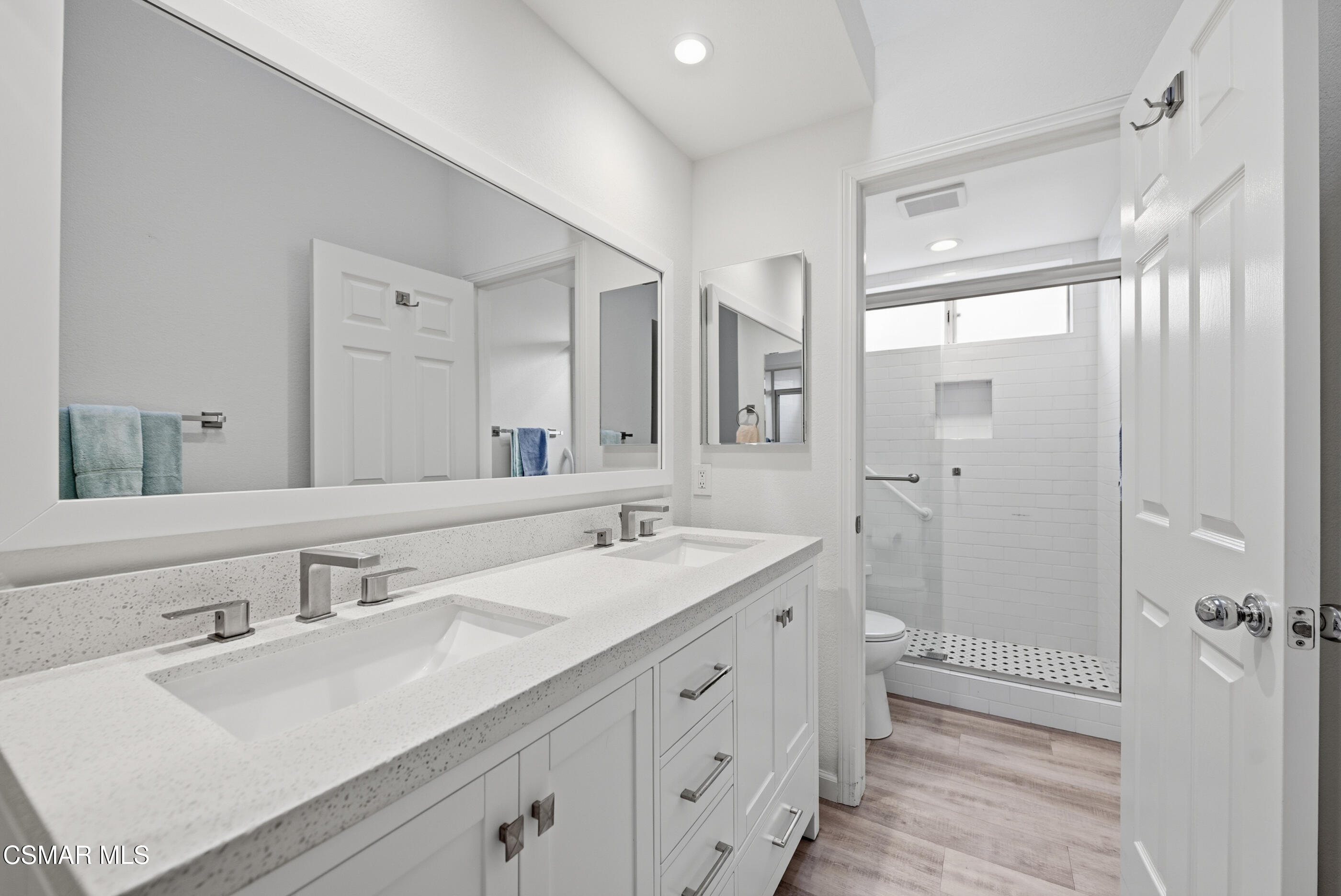 2565 Winthrop Court Simi Valley, CA 93065 - Photo 25 of 37 a bathroom with a double vanity sink mirror and shower