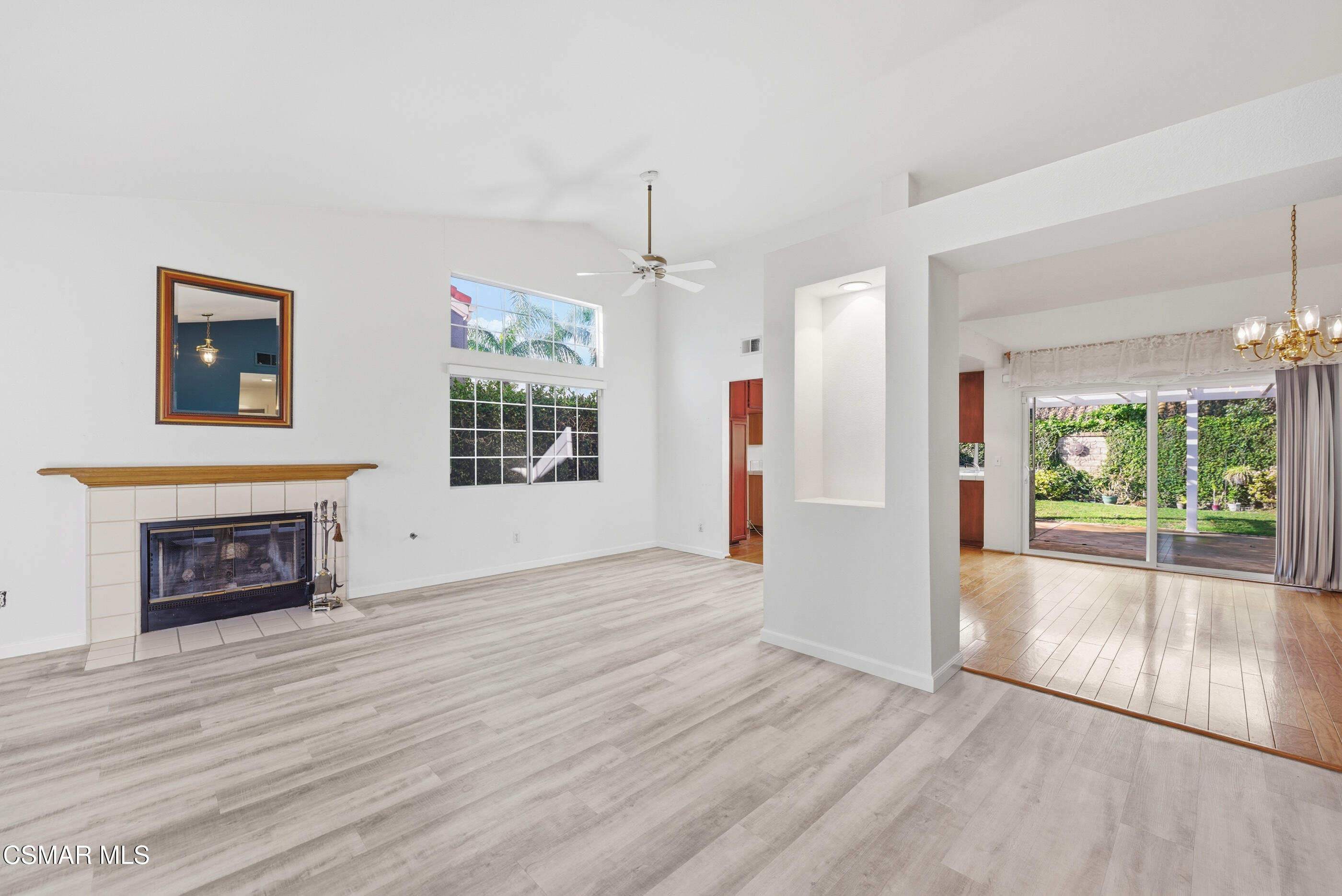 2565 Winthrop Court Simi Valley, CA 93065 - Photo 3 of 37 an empty room with wooden floor fireplace and windows
