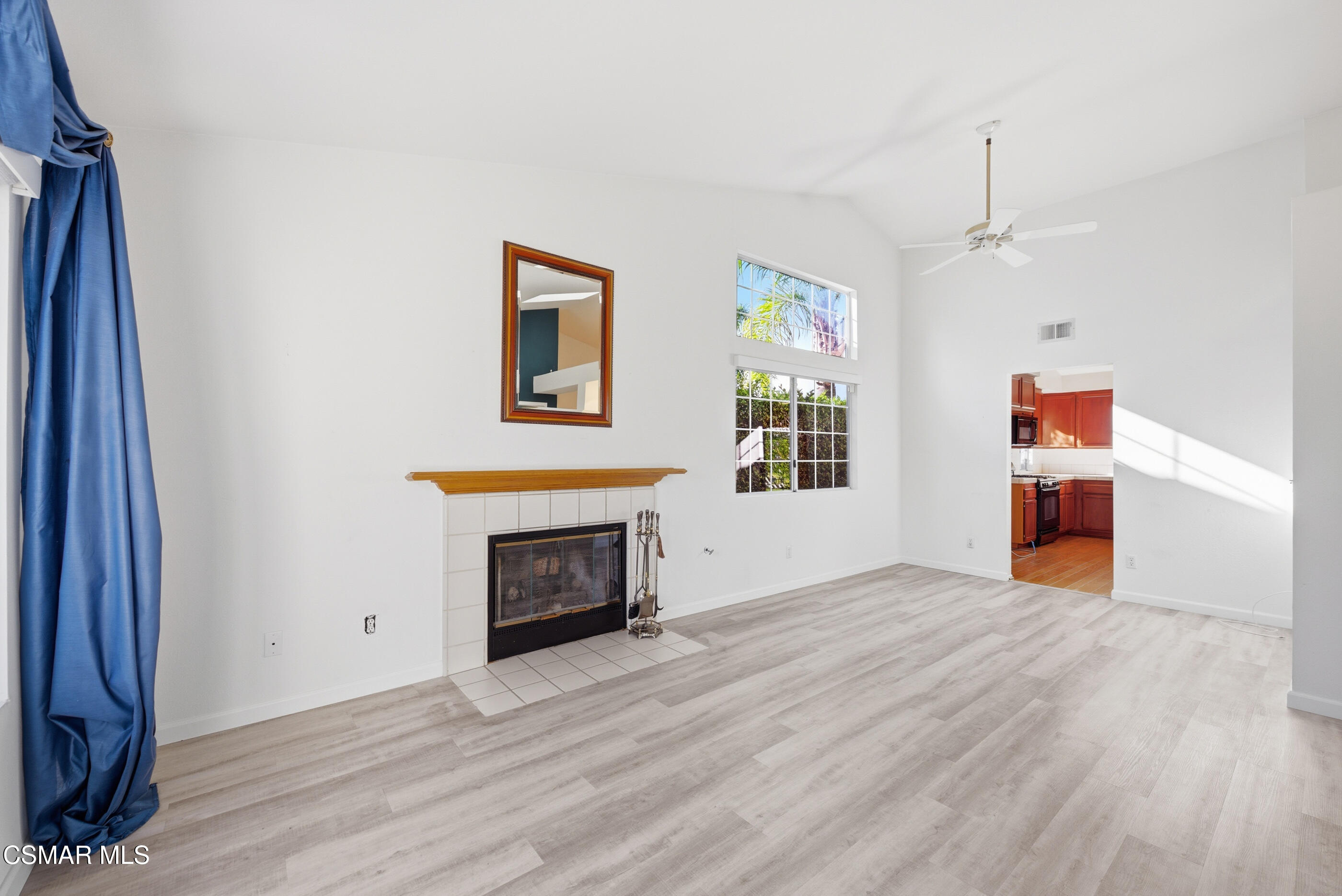 2565 Winthrop Court Simi Valley, CA 93065 - Photo 7 of 37 an empty room with wooden floor a fireplace and windows