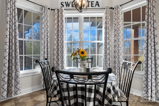 a view of a dining room with furniture and chandelier