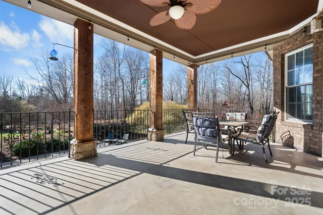 a view of a patio with a dining table and chairs with wooden floor