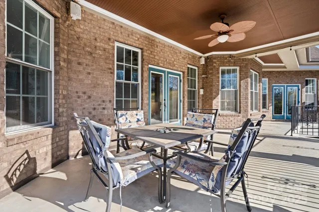 a view of an outside dining space with a table and chairs