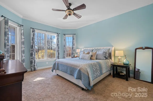 a spacious bedroom with a bed a couch and a window