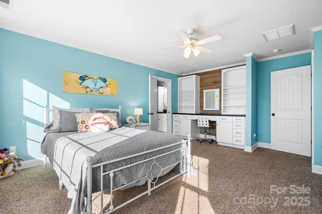 a bedroom with a large bed and a chandelier