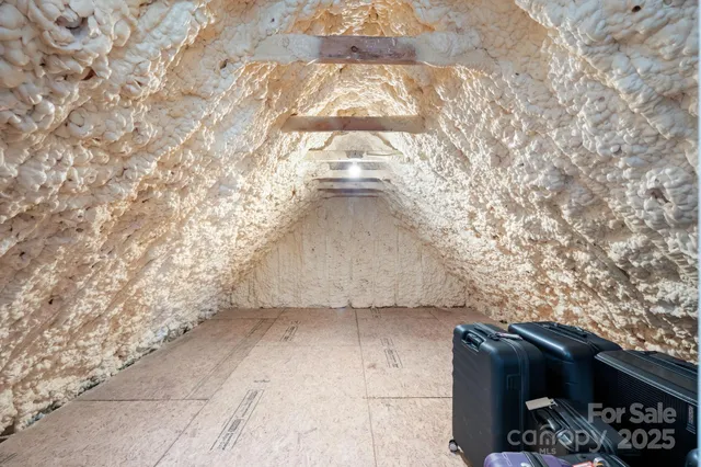 a living room with furniture a flat screen tv and large window