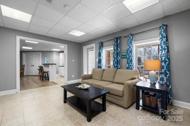 a view of a bedroom with a bed and wooden floor