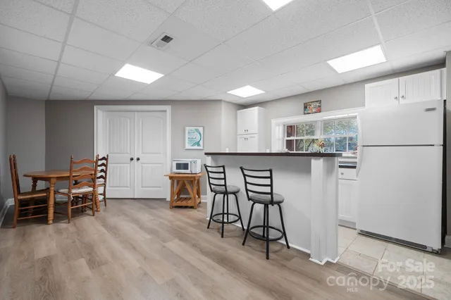 a kitchen with refrigerator and window