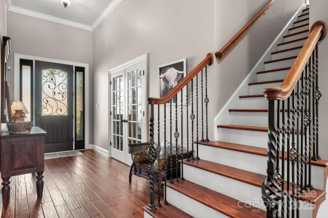 a view of entryway with wooden floor and stairs