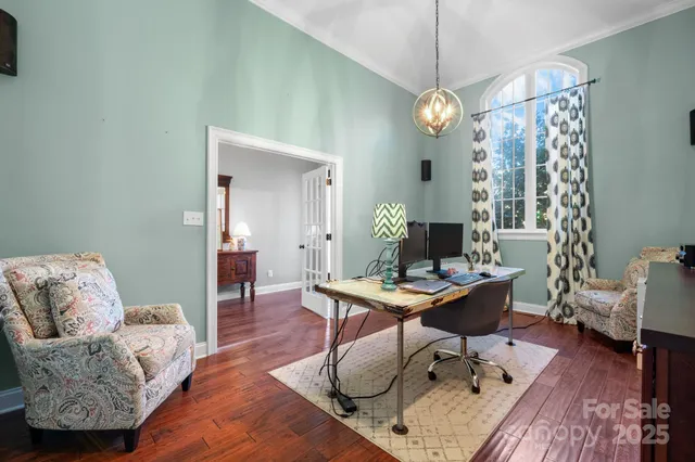 a living room with furniture a table and a chandelier