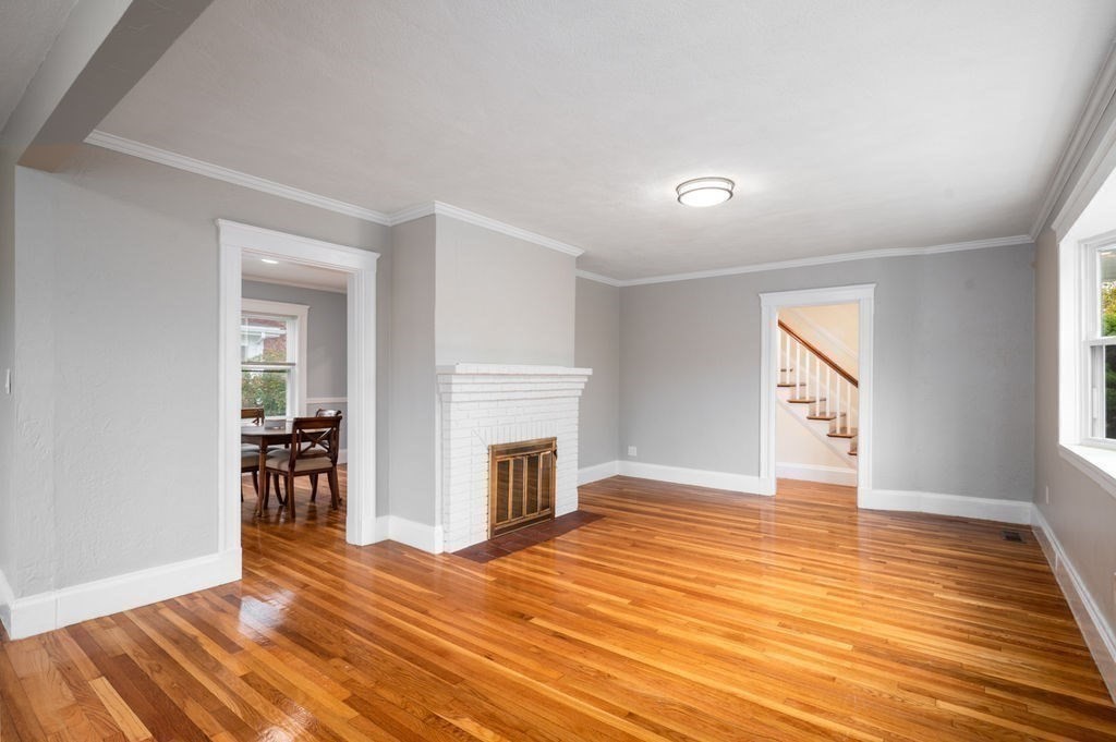 25 Tedesco Street Marblehead, MA 01945 - Photo 14 of 42 an empty room with wooden floor and fireplace