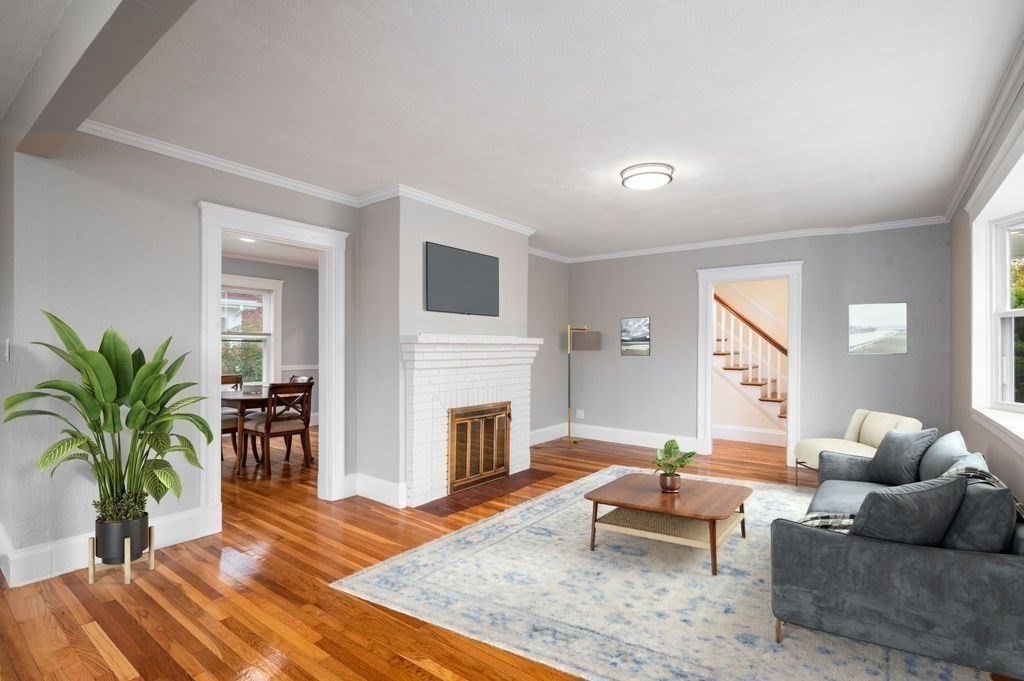 25 Tedesco Street Marblehead, MA 01945 - Photo 15 of 42 a living room with furniture fireplace and potted plants
