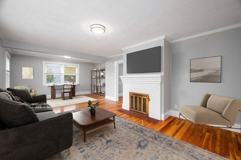25 Tedesco Street Marblehead, MA 01945 - Photo 17 of 42 a living room with furniture flat screen tv and a fireplace