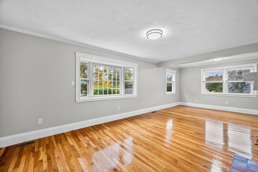 25 Tedesco Street Marblehead, MA 01945 - Photo 19 of 42 a view of an empty room with wooden floor and a window