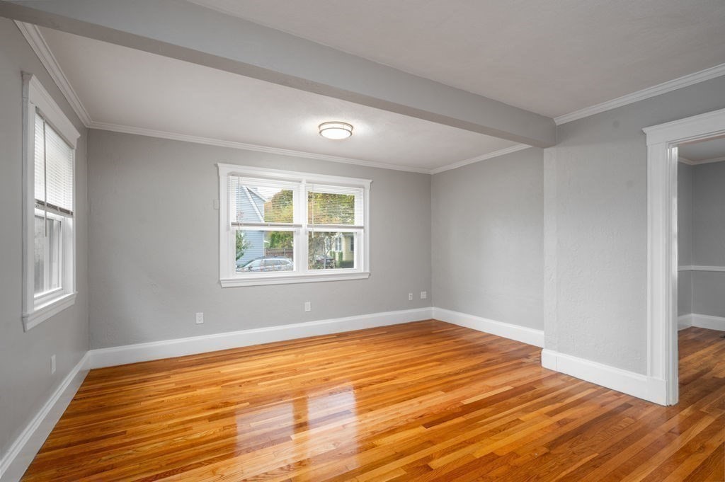 25 Tedesco Street Marblehead, MA 01945 - Photo 20 of 42 a view of an empty room with wooden floor and a window