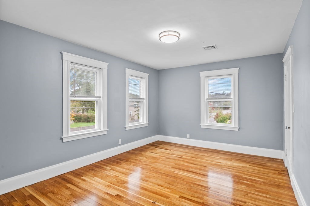 25 Tedesco Street Marblehead, MA 01945 - Photo 28 of 42 a view of an empty room with wooden floor and a window