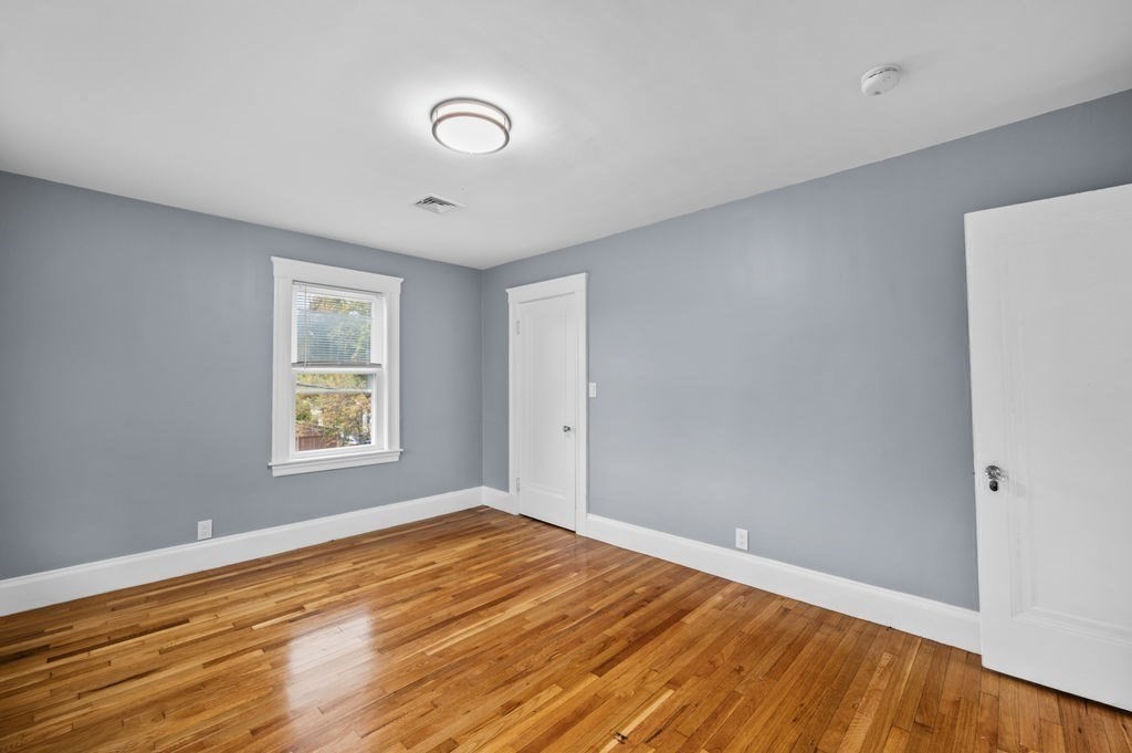 25 Tedesco Street Marblehead, MA 01945 - Photo 29 of 42 a view of empty room with wooden floor and fan