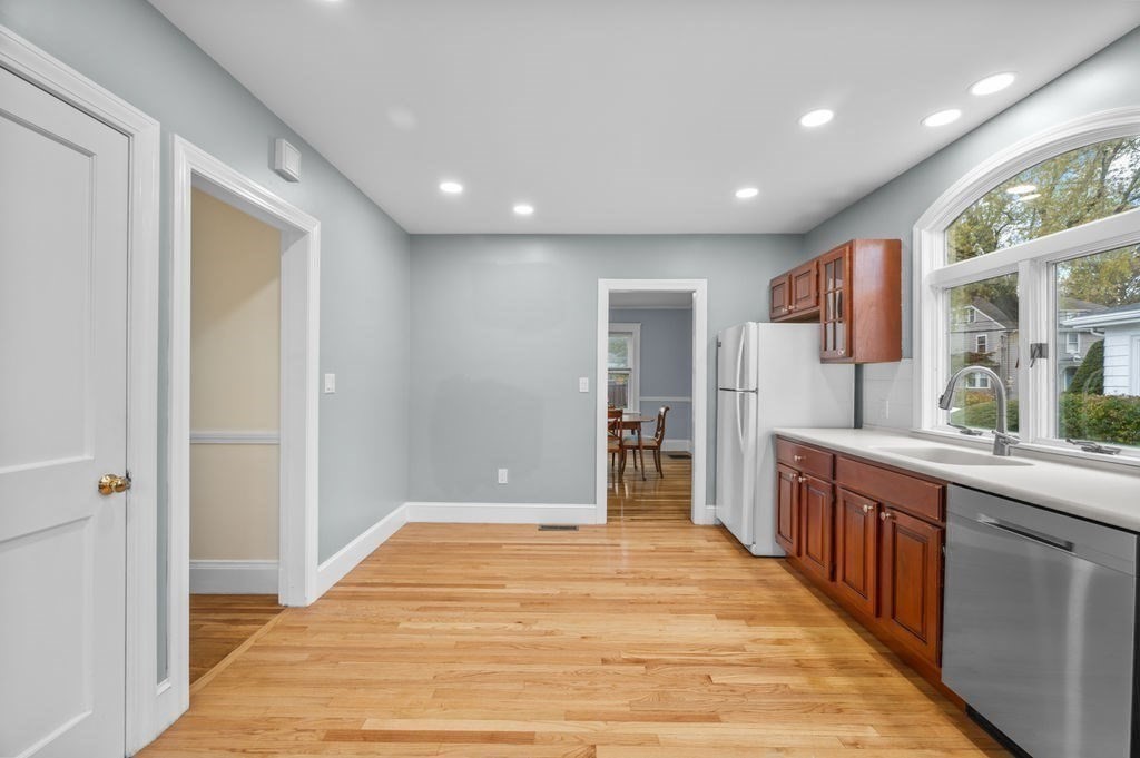 25 Tedesco Street Marblehead, MA 01945 - Photo 8 of 42 a large kitchen with stainless steel appliances granite countertop a large counter top a sink and a refrigerator