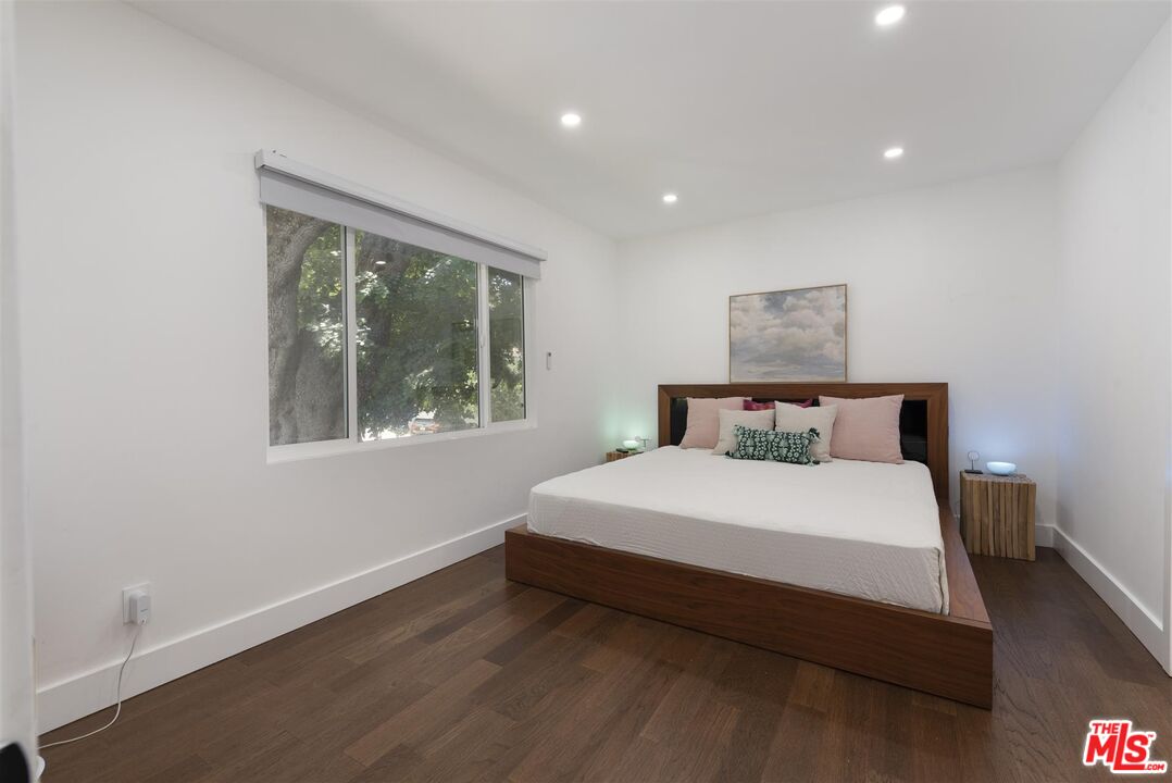 2429 Outpost Drive Los Angeles, CA 90068 - Photo 12 of 29 a large bed sitting in a bedroom next to a window