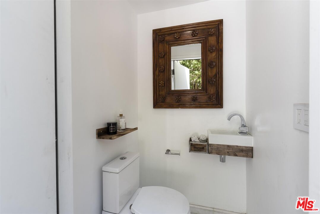 2429 Outpost Drive Los Angeles, CA 90068 - Photo 16 of 29 a bathroom with a toilet sink and mirror