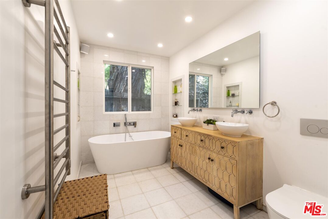 2429 Outpost Drive Los Angeles, CA 90068 - Photo 18 of 29 a spacious bathroom with a double vanity sink mirror and bathtub