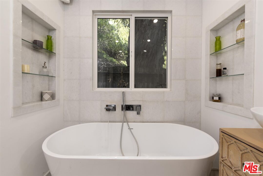 2429 Outpost Drive Los Angeles, CA 90068 - Photo 19 of 29 a white bath tub sitting next to a shower