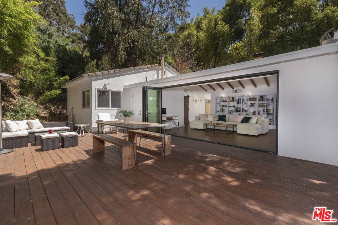 2429 Outpost Drive Los Angeles, CA 90068 - Photo 5 of 29 a view of a patio with table and chairs with wooden floor and fence