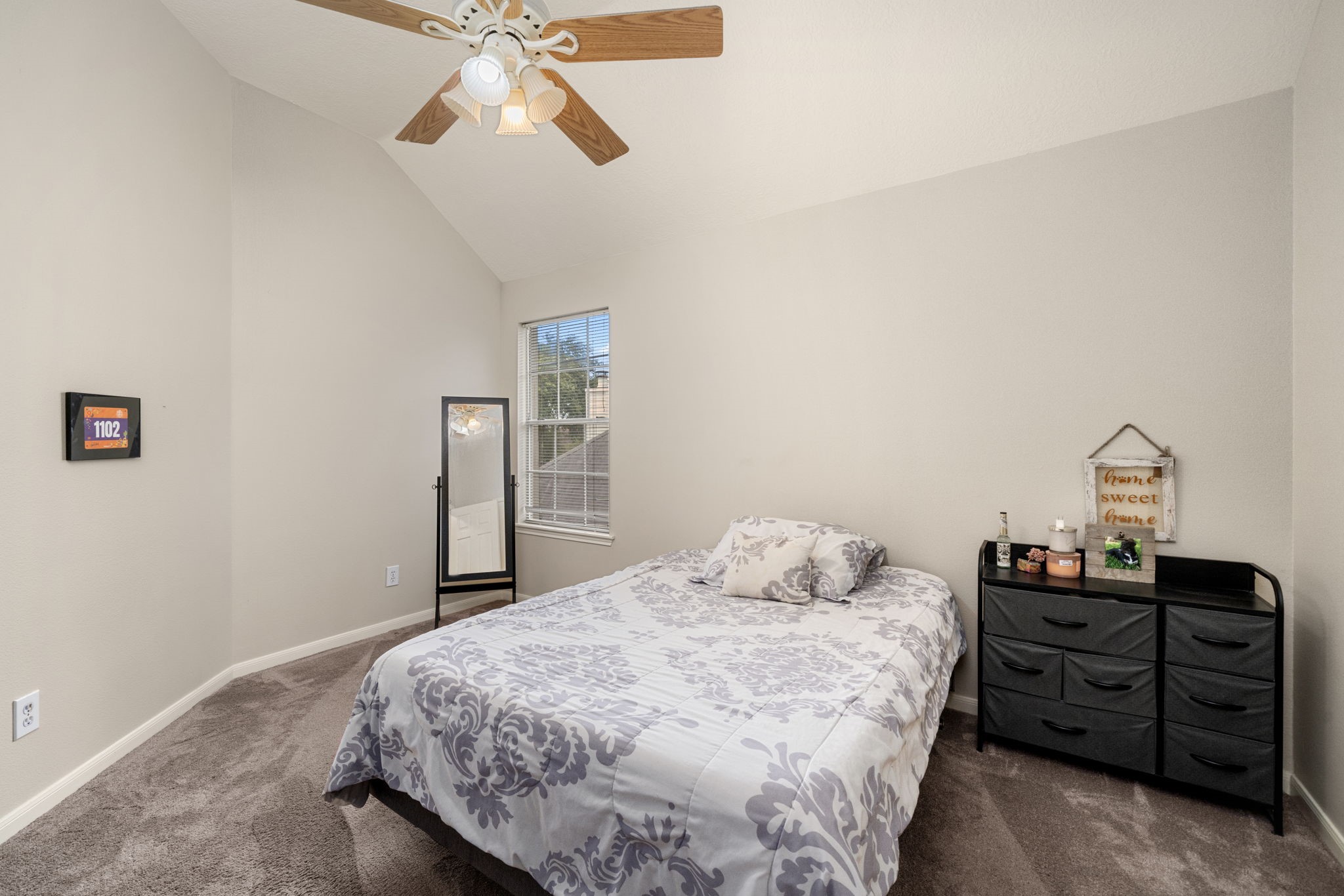 9715 Therrell Drive Houston, TX 77064 - Photo 25 of 33 a bedroom with a bed and dresser with chandelier