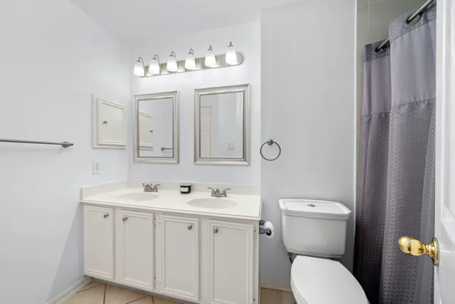 a bathroom with a sink mirror and toilet