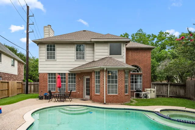 a front view of a house with a yard table and chairs