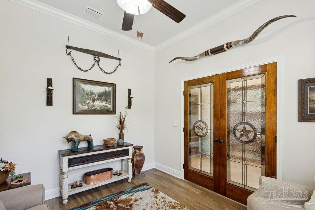 3480 Red Ryder Lane Pace, FL 32571 - Photo 15 of 47 a view of a hallway with paintings on the wall