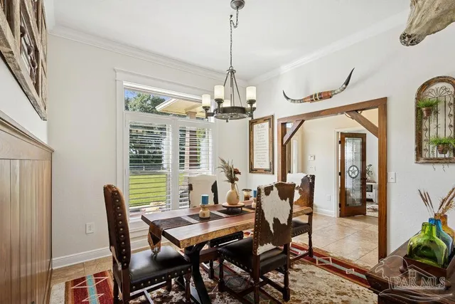 a dining room with furniture a chandelier and a rug