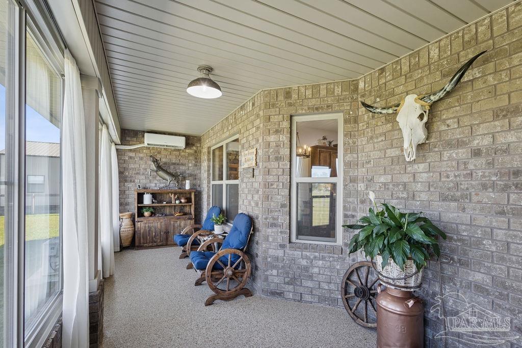 3480 Red Ryder Lane Pace, FL 32571 - Photo 19 of 47 a view of a hallway with outdoor seating