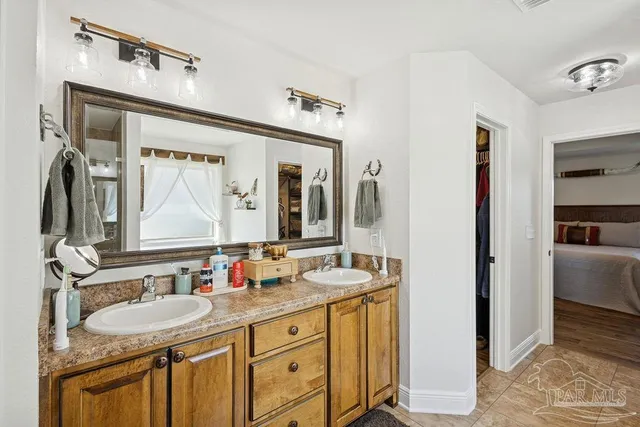 a bathroom with a granite countertop sink double vanity