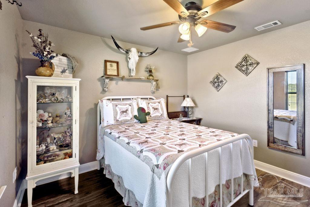 3480 Red Ryder Lane Pace, FL 32571 - Photo 22 of 47 a bedroom with a bed and a chandelier
